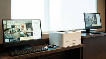 Two desktop computers displaying real estate listings.