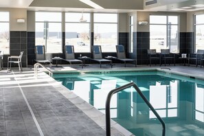 A swimming pool area with lounge chairs and a view of the outdoors. - Residence Inn by Marriott Wilkes-Barre Arena (Wilkes-Barre)