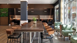 A modern conference room with a long table, multiple chairs, and a potted plant. - Courtyard by Marriott Fresno Clovis (Clovis)