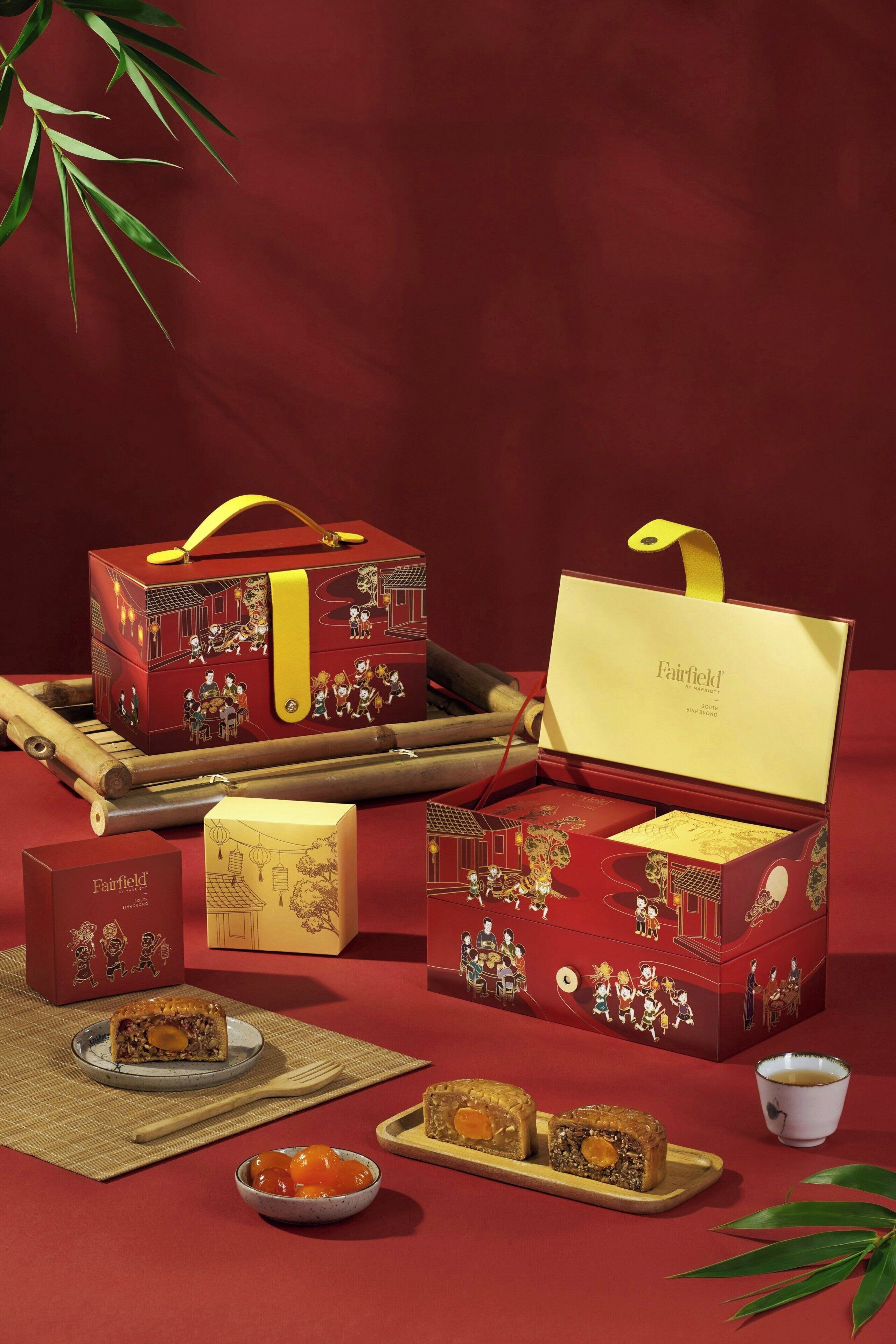 A collection of red gift boxes with yellow handles, a tea set, and a bamboo flute.