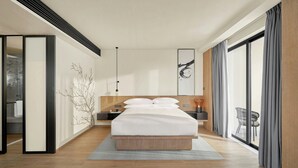 A modern hotel room with a large bed, a nightstand, a wall-mounted artwork, and a view through a large window.