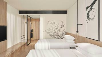 A modern hotel room with a large bed, a flat-screen TV, and a minimalist decor.