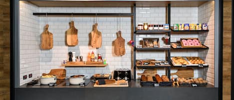 A bakery display with various baked goods and kitchen utensils.