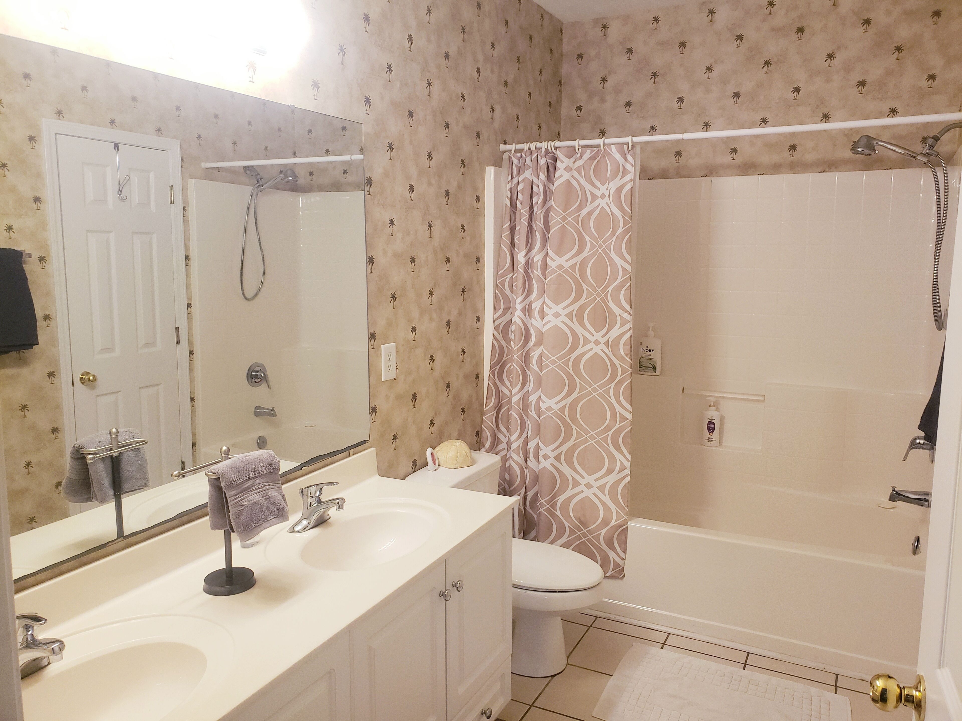 A bathroom with a bathtub, a toilet, a sink, and a shower.