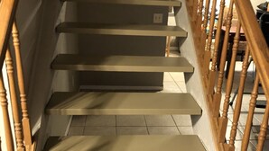 A staircase with wooden balusters and beige steps.