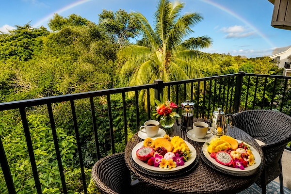 Private lanai surrounded by lush greenery, perfect for morning coffee