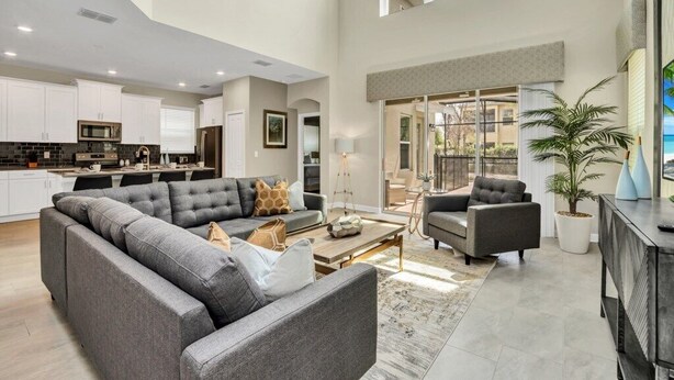 A spacious living area with a sectional sofa, a coffee table, and a fireplace.