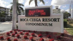 A sign for Boca Ciega Resort Condominium with a digital display showing the temperature as 79°F and the time as 1:46. - Sky view of sunsets and TAMPA BAY !! (St. Petersburg)