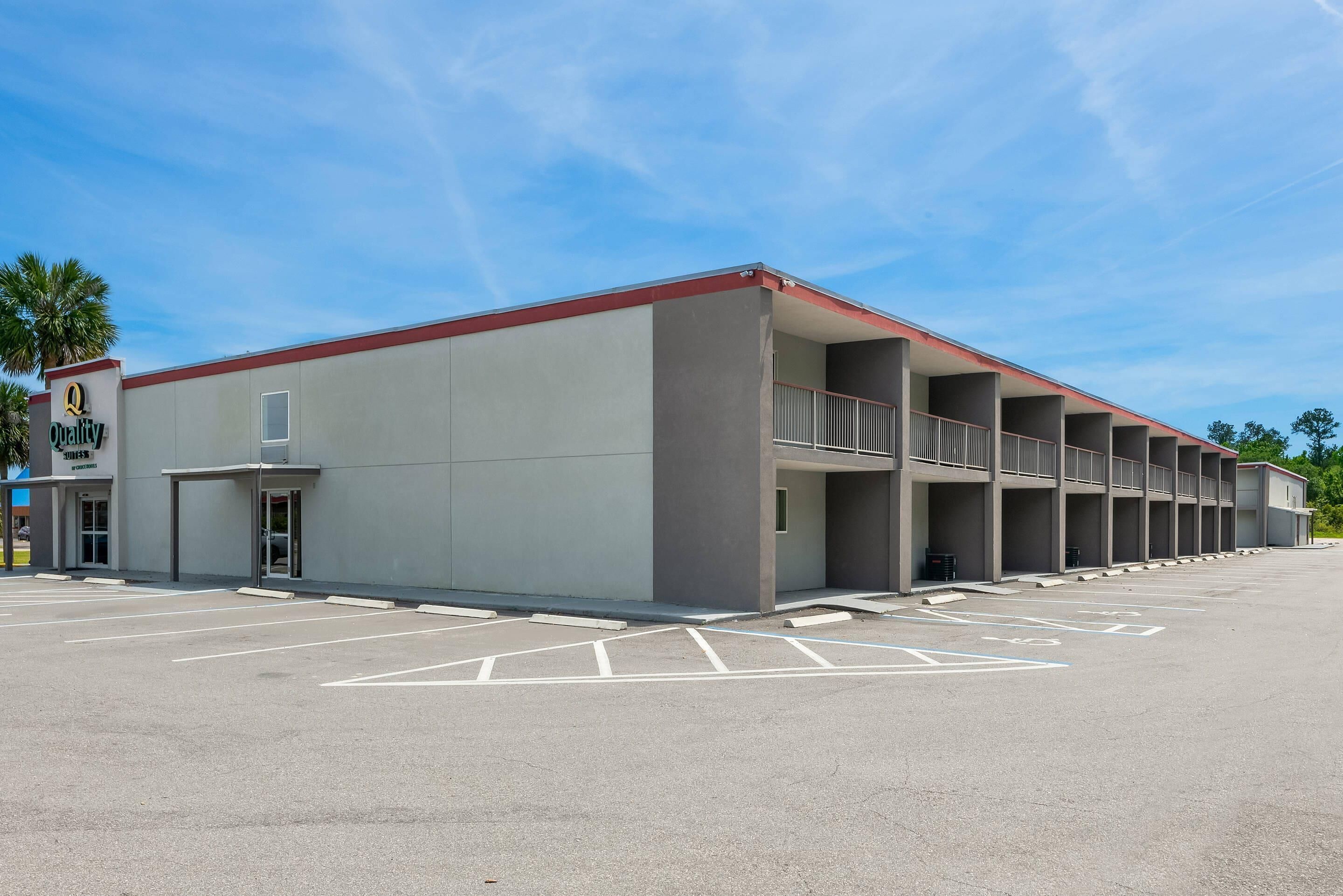 A multi-story parking garage with a flat roof and a series of balconies.
