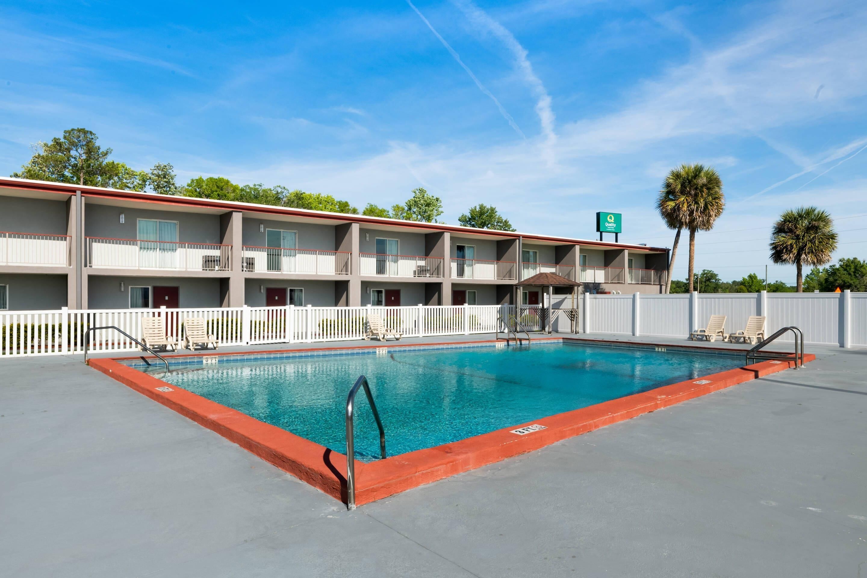 Una piscina al aire libre, tumbonas