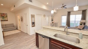 A modern kitchen with granite countertops, a dishwasher, and a sink. - 1D | Gated Complex | Daily Needs in Walking Distance  (Katy)