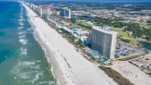 A coastal hotel with multiple high-rise buildings, a beach, and a golf course. - Beachfront Family Condo. Luxury Resort. Sleeps 4-6 (Panama City Beach)