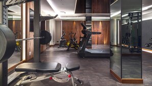 A gym with weightlifting equipment, treadmills, and exercise bikes. - My Story Gdynia (Gdynia)