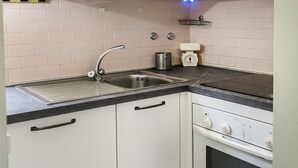 A kitchen with a sink, stove, and cabinets. - M297 - Marcelli, three-room apartment with garden at 100 m. from the sea (Marcelli)