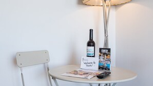 Une table avec une bouteille de vin, une carte touristique et un panneau d’accueil.