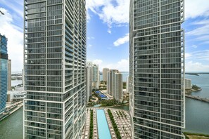 A high-rise building with a central courtyard featuring a swimming pool, surrounded by other high-rise buildings. - ICON W BRICKELL OCEAN VIEW 2BR/2BA #3310 (Miami)