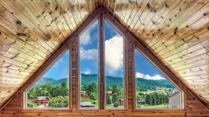 A triangular wooden ceiling with a large window. - Read Our Reviews! Indoor Pool + Outdoor Pool + View (Sevierville)