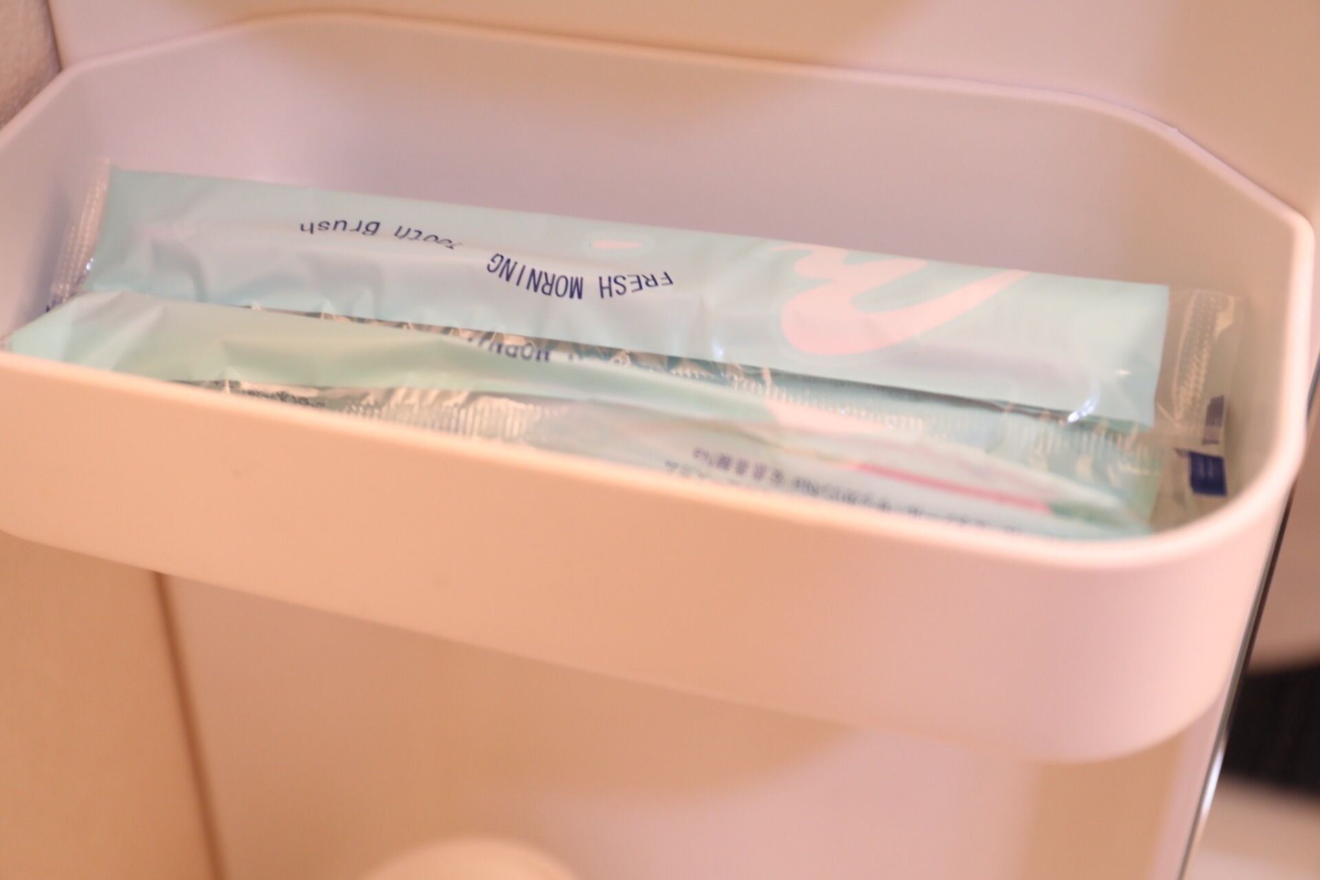 A toilet with a tissue box labeled "MORNING BREEZE" and a tissue roll.