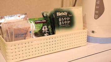 A tray with various coffee pods and a drip coffee maker on a table.