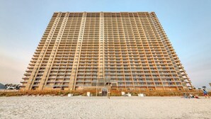 A tall, rectangular hotel with a uniform facade, multiple balconies, and a flat roof. - *Sept 6- 8th/Labor Day Open!* Beach chairs included! (Panama City Beach)
