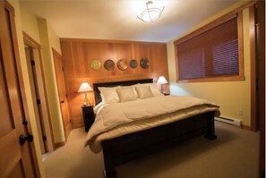 Cozy retreat with a large bed, bedside tables, and wall decorations.