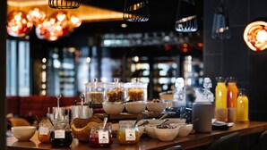A breakfast buffet with various food items and condiments.