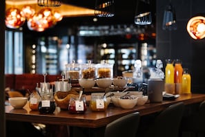 A breakfast buffet with various food items and condiments.