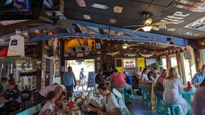 A restaurant with outdoor seating, a ceiling fan, and string lights. - Cozy Cove- Fenced yard for your dog and calm waters to swim for the family (Moneta)