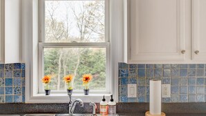 A kitchen with a window, a sink, and a countertop. - Robeson Retreat (Sag Harbor)