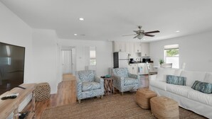 A modern living room with a flat-screen TV, two patterned armchairs, a white sofa, and a ceiling fan. - ☀️GulfViews~Additional Carriage House~100yds2Beach~PRIMELocation~Grayton Escape (Santa Rosa Beach)