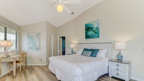 A bedroom with a large bed, a desk, and a chair. - Pet Friendly | Ocean Views | Across the Road from the Beach | The Round House (Fernandina Beach)