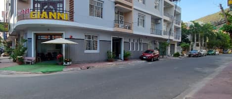 A hotel named 'Hotel GIANNI' with a modern design, featuring balconies and a flat roof.