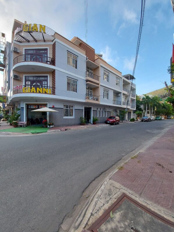 A hotel named 'Hotel GIANNI' with a modern design, featuring balconies and a flat roof.