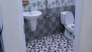 A bathroom with a shower, sink, and toilet. - An Binh Hotel (Ho Chi Minh City)