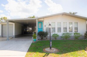Welcome to this charming single-story home with a garage and driveway, featuring a bright front door and cozy porch area.