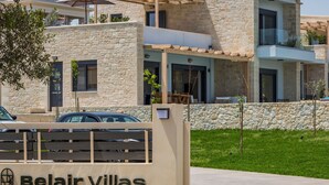A modern building with stone facade and balconies, labeled "Belair Villas." - Perfect location, private pool, hot tub and gym! (Chania)