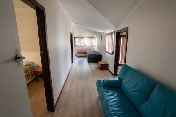 Hallway with 3 single beds plus lounge.