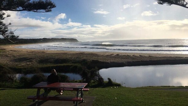 A picnic table by a lake with a view of the ocean and a distant island. - Beachside, Pet friendly, Paradise. (Black Head)