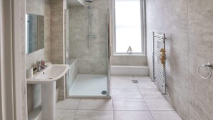 A modern bathroom with a glass-enclosed shower, a white sink, and a bathtub. - Host & Stay | The Glaisdale (Whitby)