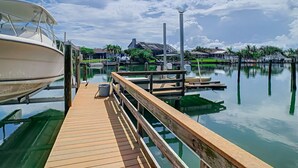 A wooden dock extending into calm water with boats docked on the left. - Waterfront  (Clearwater)
