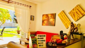 A hotel reception area with a red sofa, a wooden counter, a map display, and a statue of a horse. - 2 connected villas 19 Pax (Playa del Carmen)