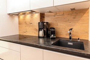 Fridge, stovetop, dishwasher, coffee/tea maker