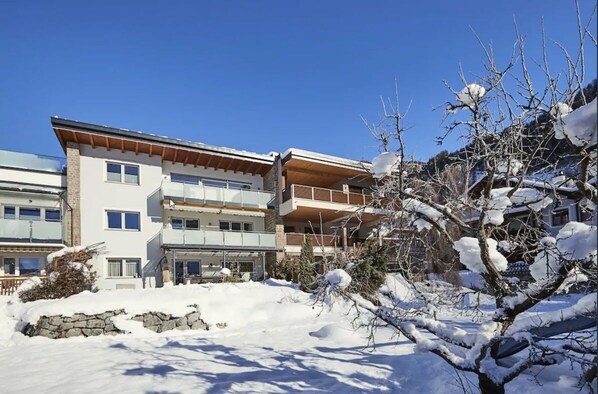 A multi-story hotel with a modern architectural design, featuring balconies and large windows. - Modern apartments in a prime location – your perfect Holiday Home in Tyrol. (Ried im Oberinntal)