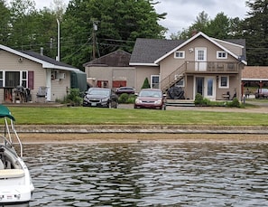 A house with a garage, a covered porch, and a small deck.