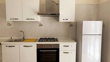 Een koelkast, een oven, een kookplaat, een koffiezetapparaat/waterkoker