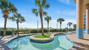 A swimming pool with a 3 ft depth limit, surrounded by palm trees and a clear blue sky.