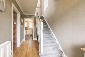 Staircase leads to a well-appointed living space with a kitchen area and a welcoming atmosphere.