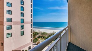 A balcony with a view of a beach and ocean. - · NEW! Stunning Condo, Sleeps 6. Waterpark, Pools and Lazy Rivers! (Myrtle Beach)