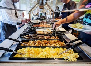 Enjoy a diverse spread of breakfast options at our hotel's communal dining area.