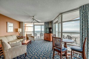 Enjoy ocean views from the balcony, featuring a sofa, table, and chairs.